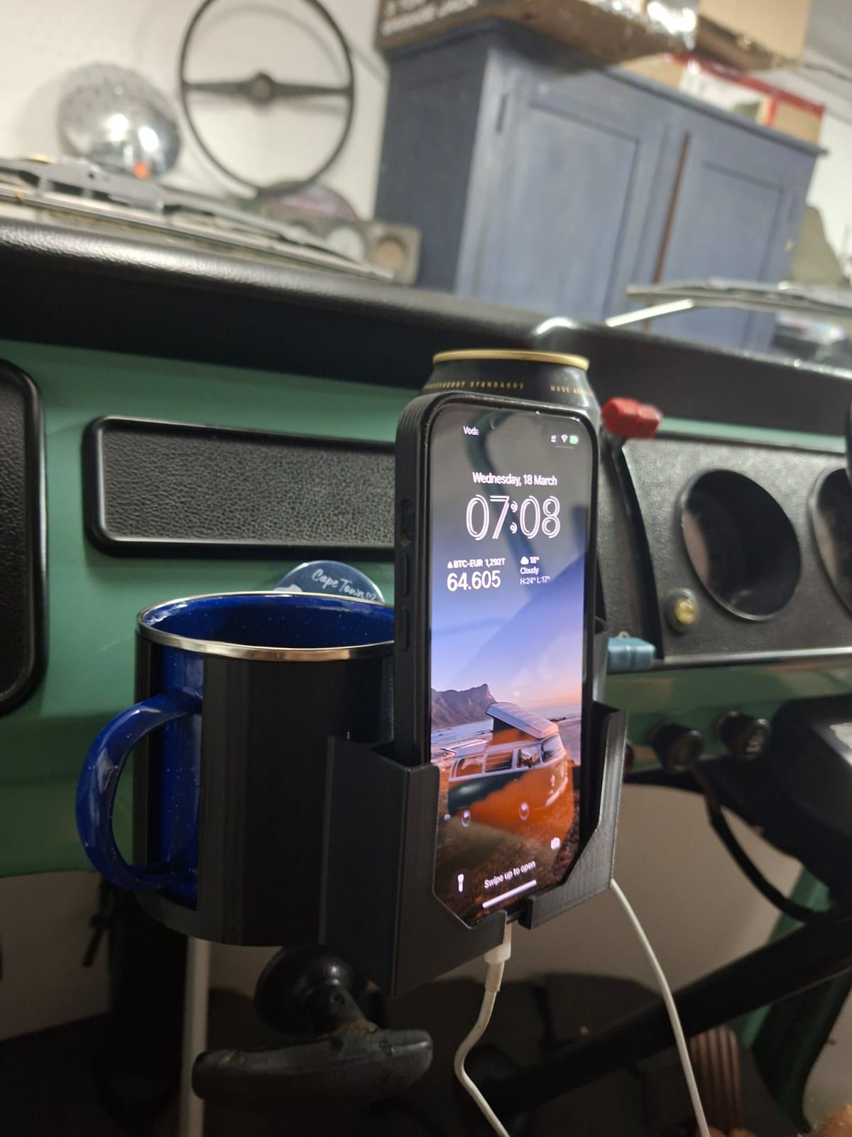 Close-up of cup holder with can and mug